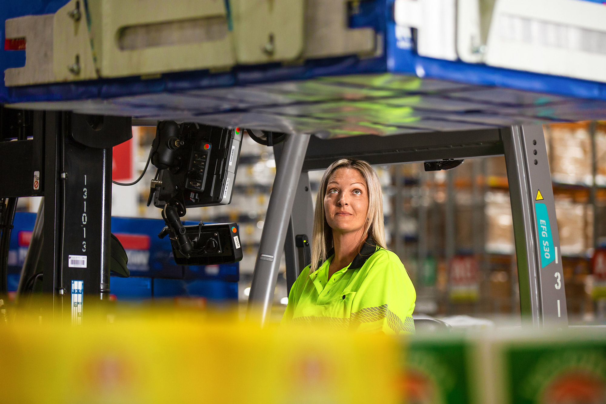 worker operating forklift in warehouse